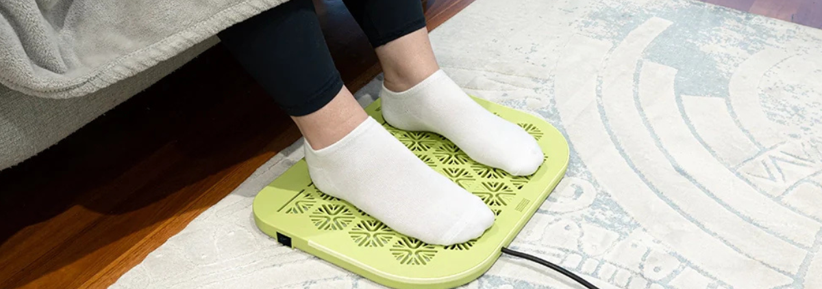 man in socks on a heated foot warmer from heatka